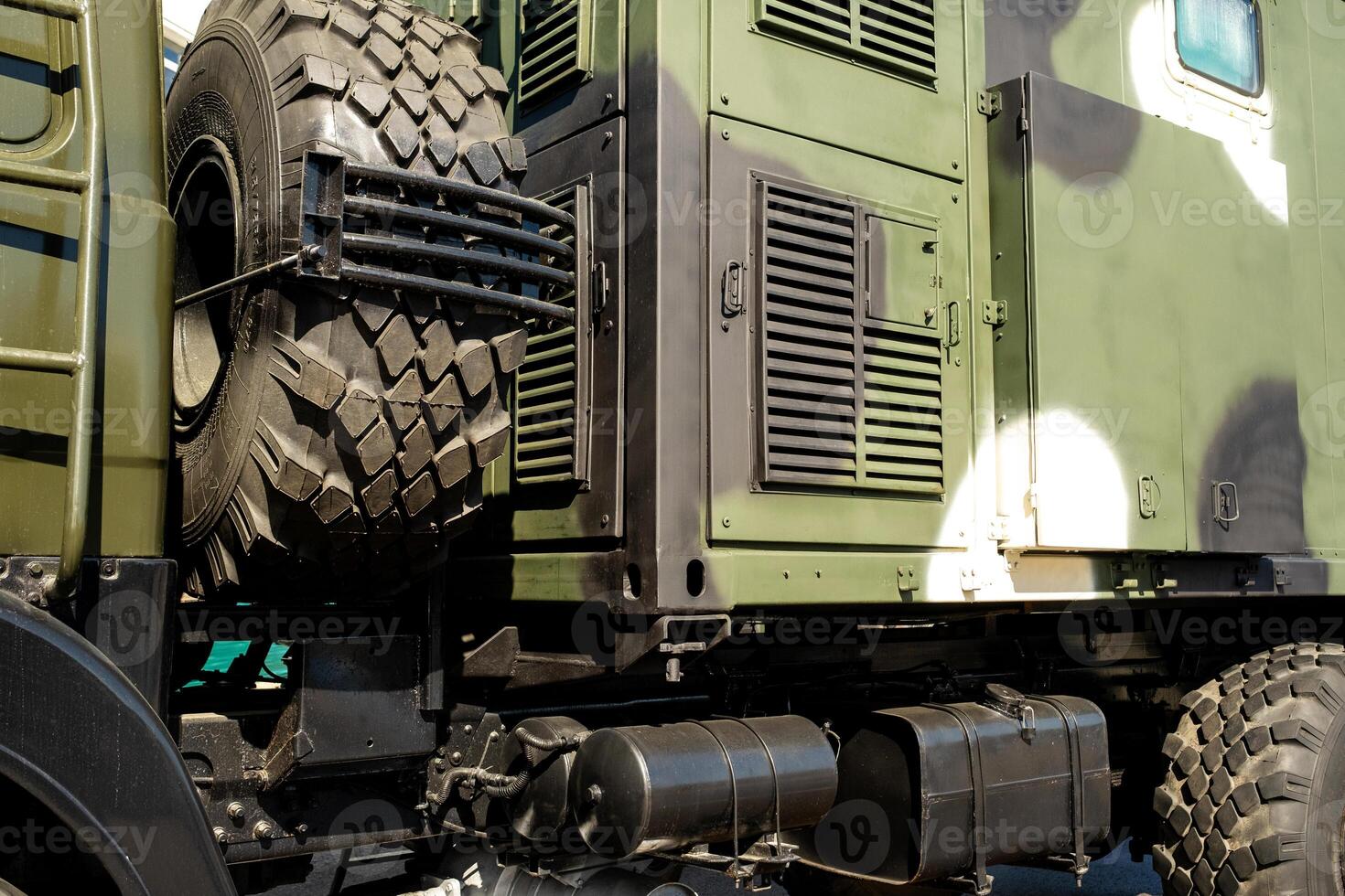 A close-up of the body of a military car on the side is green. Military concept photo