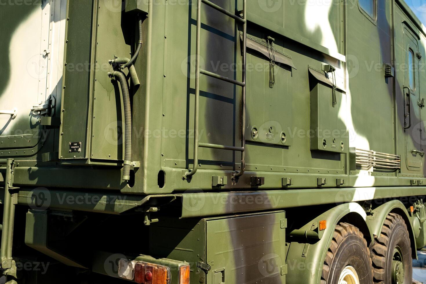 A close-up of the body of a military car on the side is green. Military concept photo