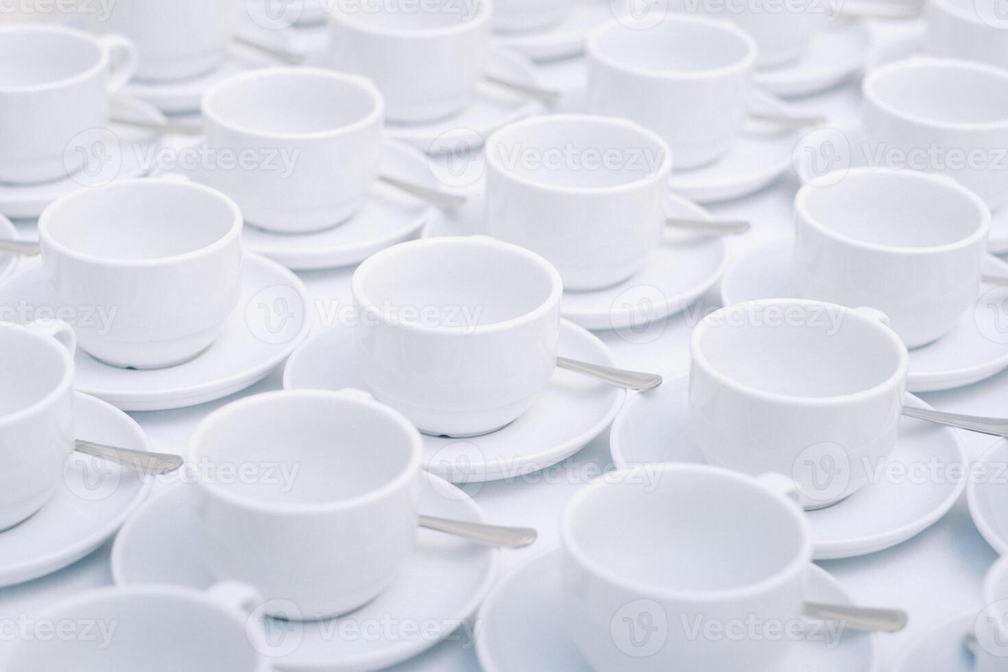 White tea cups with saucer standing on the table. photo