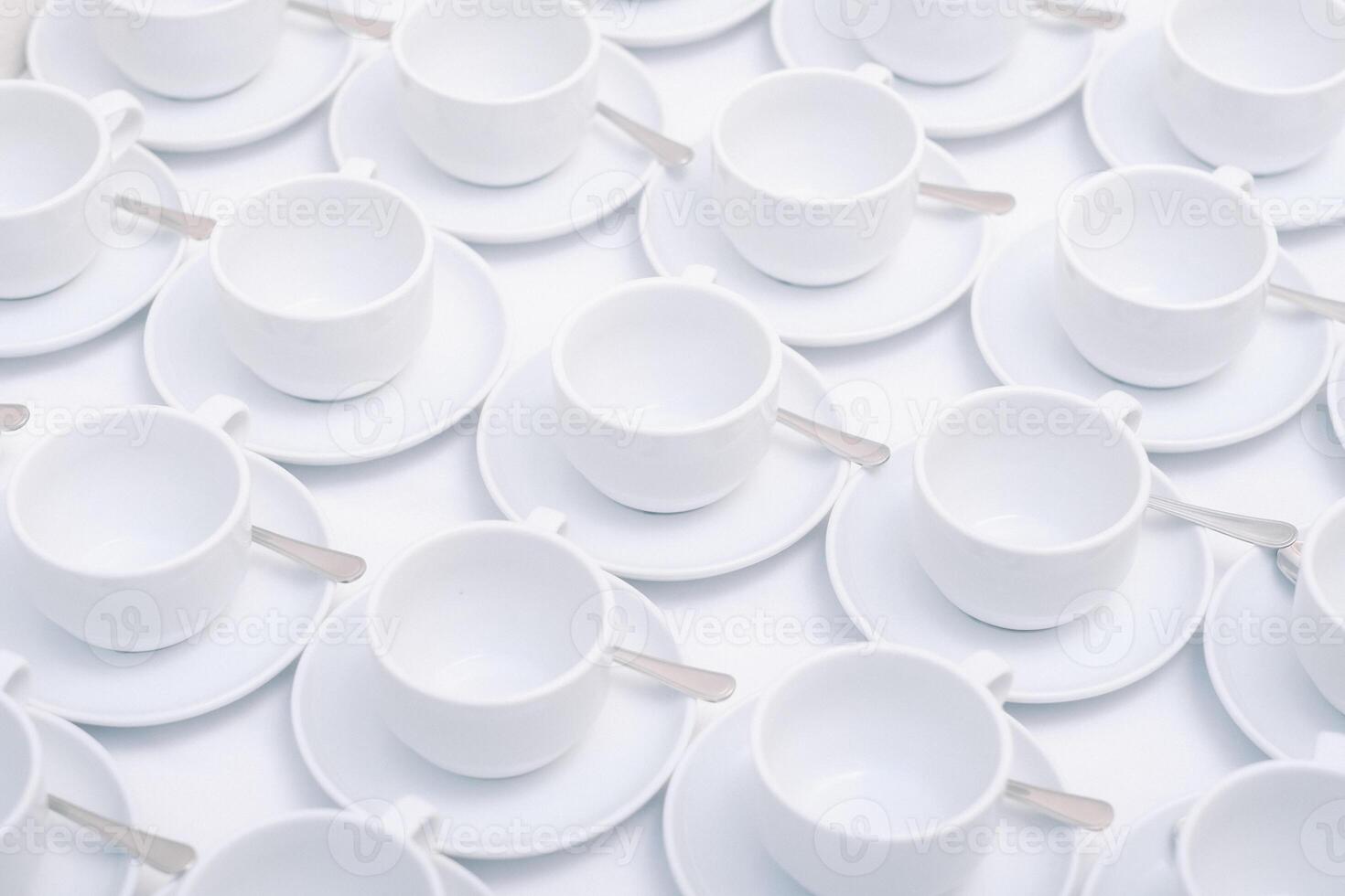 White tea cups with saucer standing on the table. photo