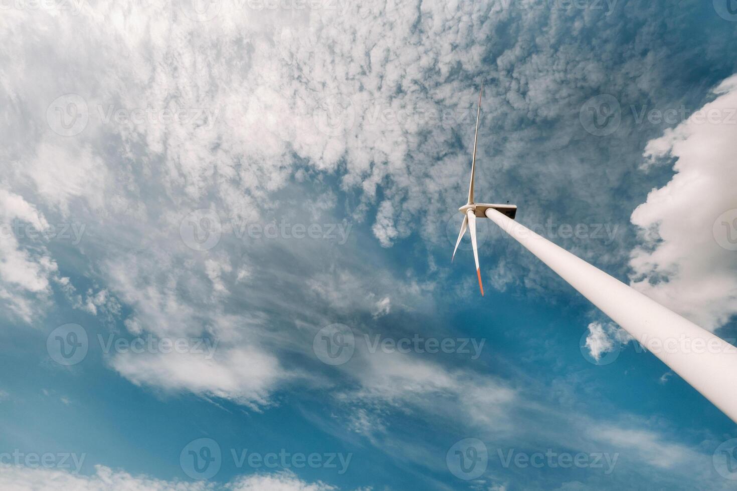 A white Windmill against a blue sky. Windmill in nature photo