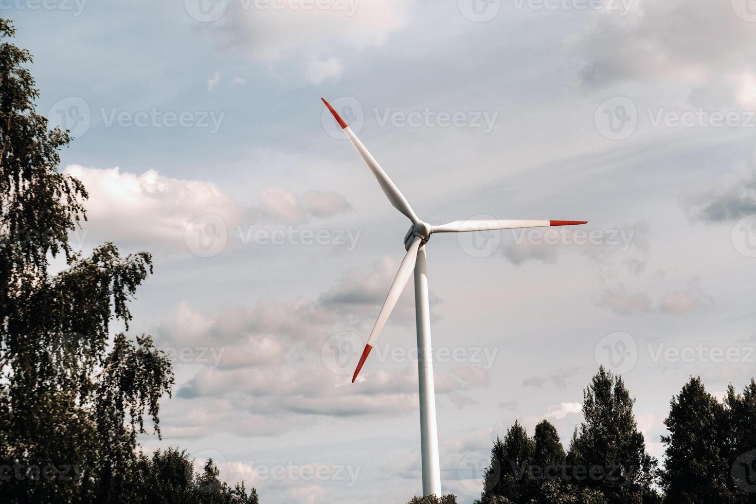 A white Windmill against a blue sky. Windmill in nature photo