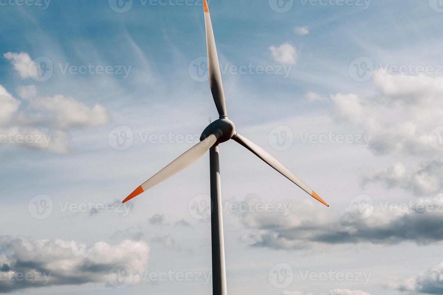 A white Windmill against a blue sky. Windmill in nature photo