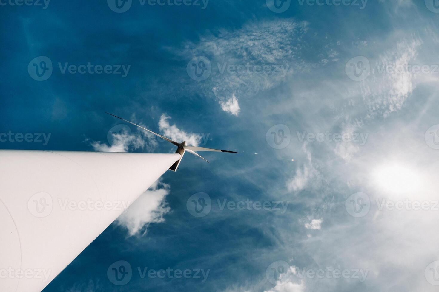 A white Windmill against a blue sky. Windmill in nature photo