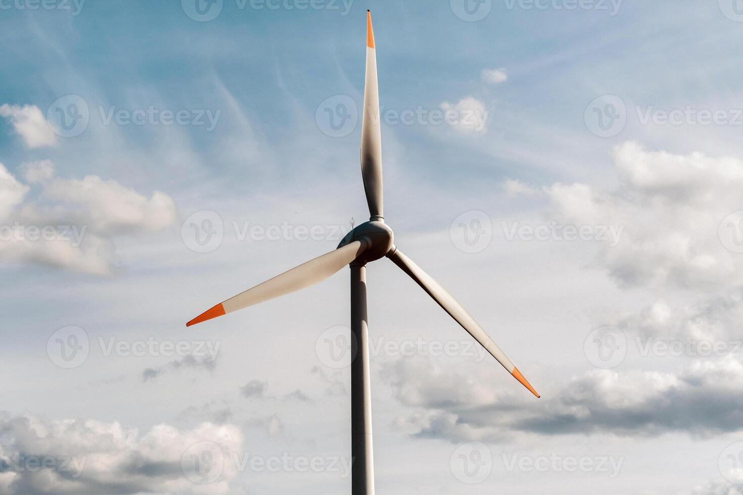 A white Windmill against a blue sky. Windmill in nature photo
