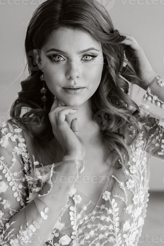 Close-up portrait of a luxurious bride in a wedding dress in the morning in her interior photo