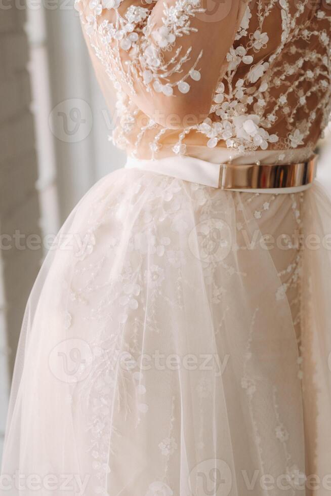 A luxurious bride in a wedding dress in the morning in her interior photo
