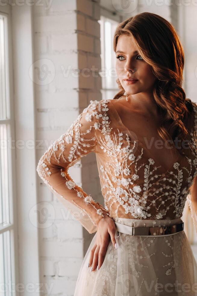 A luxurious bride in a wedding dress in the morning in her interior photo