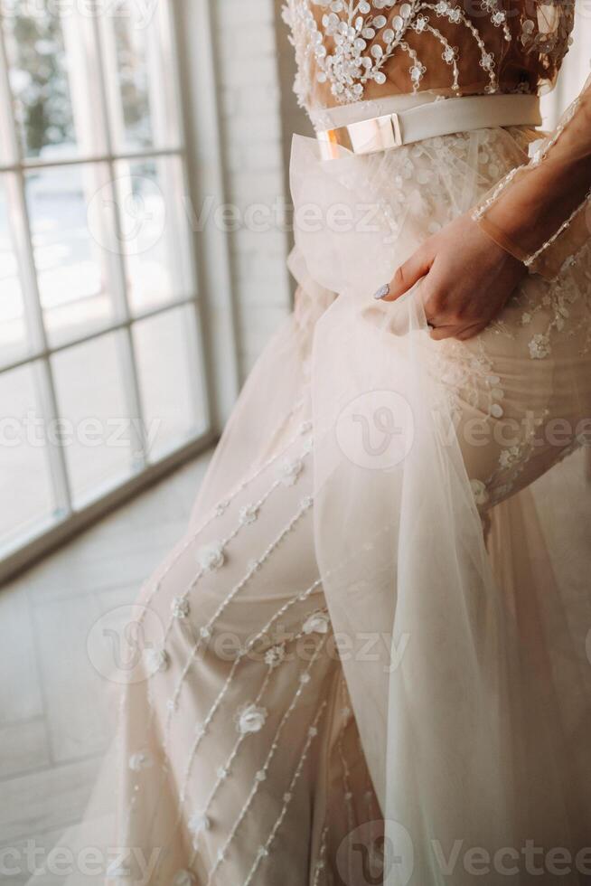 A luxurious bride in a wedding dress in the morning in her interior photo