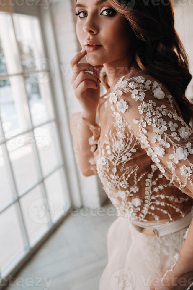 A luxurious bride in a wedding dress in the morning in her interior photo