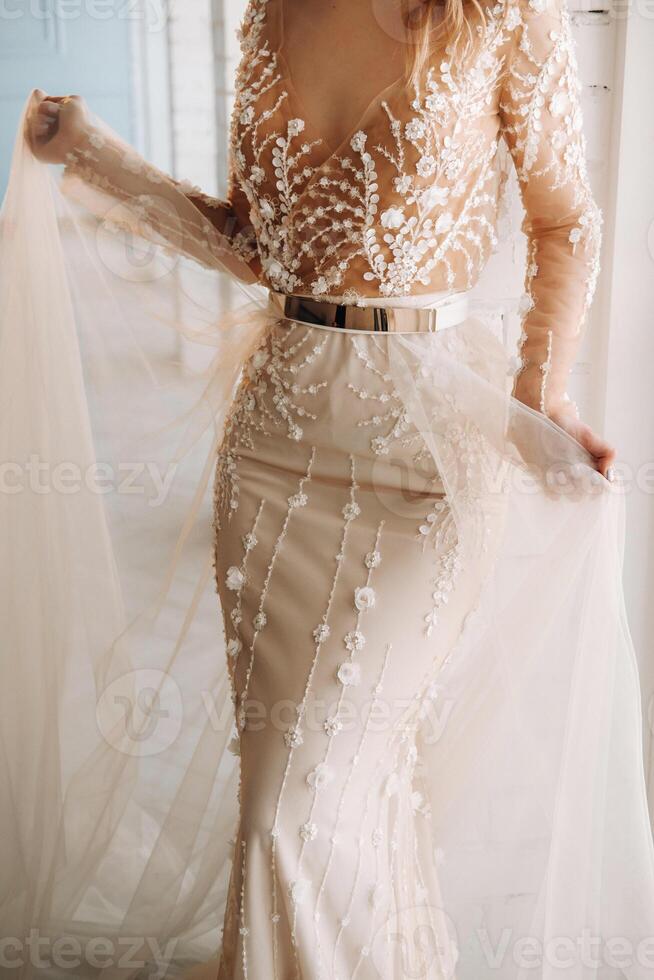 A luxurious bride in a wedding dress in the morning in her interior photo