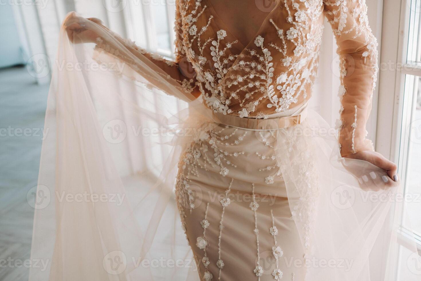 A luxurious bride in a wedding dress in the morning in her interior photo