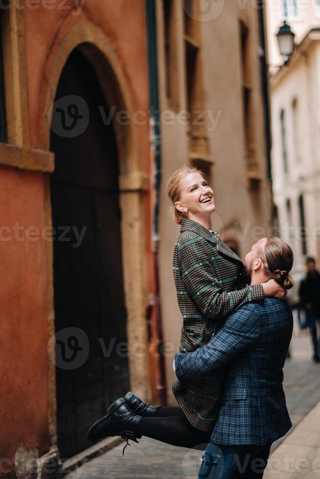 Beautiful family with walks in the old city of Lyon in France.A couple walks through old Lyon in France photo