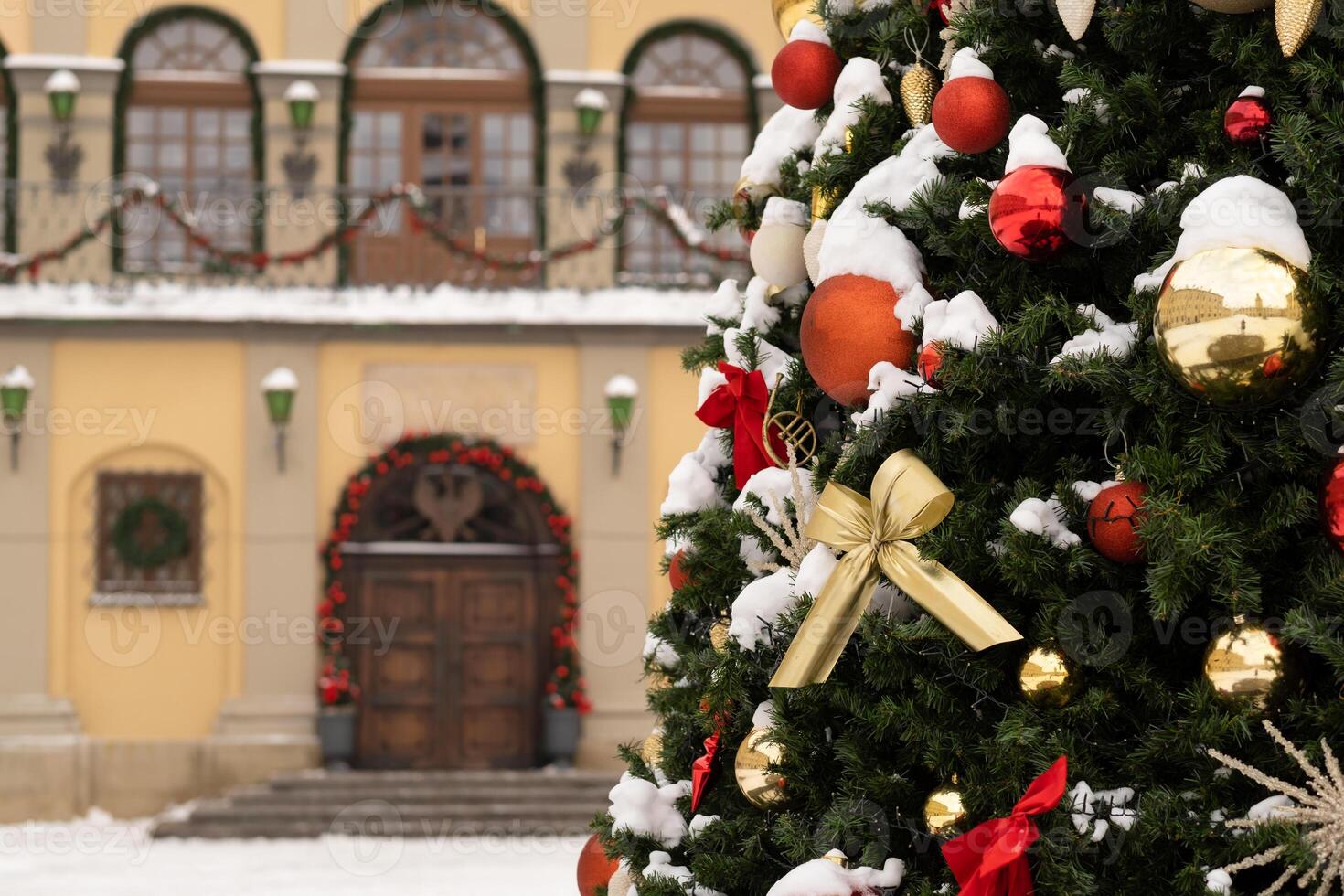Close-up of a decorated Christmas tree standing outside in the snow photo