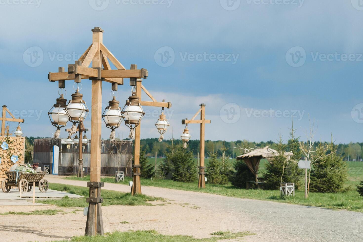 Old wooden lanterns hanging on a wooden pole photo