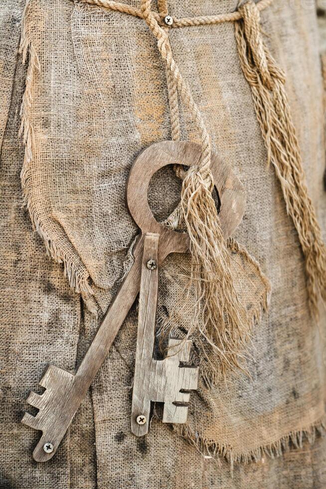 A bunch of old wooden keys hanging on a rope, close-up photo