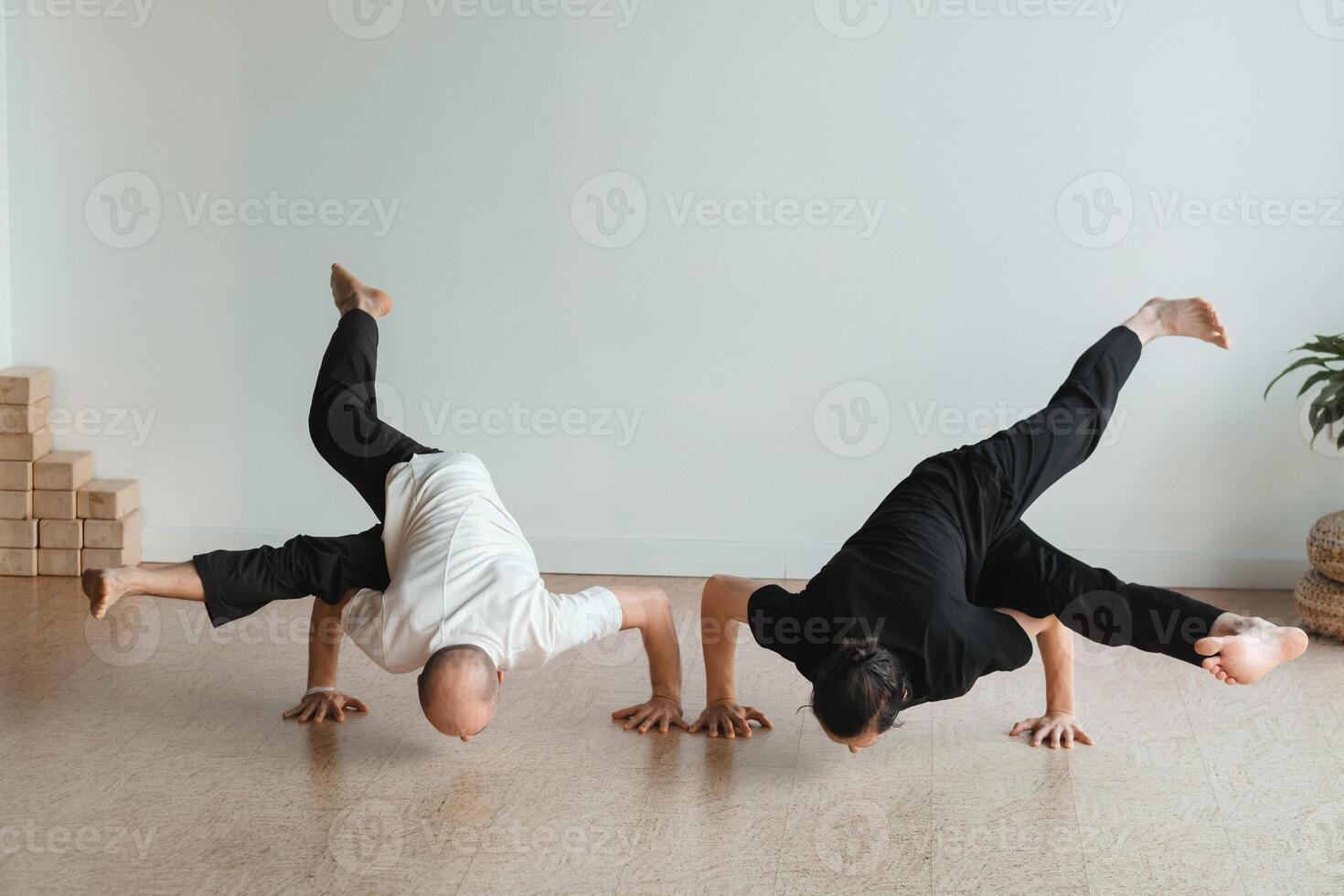 two young athletes practice yoga in the gym. Joint training, indoors, studio. The concept of a healthy lifestyle photo