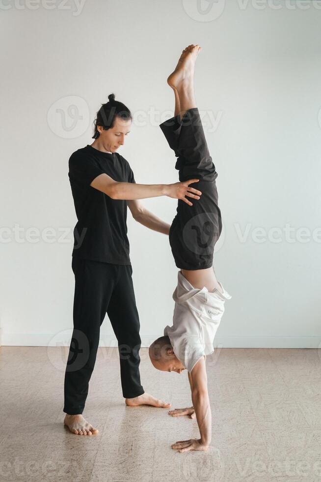 two young athletes practice yoga in the gym. Joint training, indoors, studio. The concept of a healthy lifestyle photo