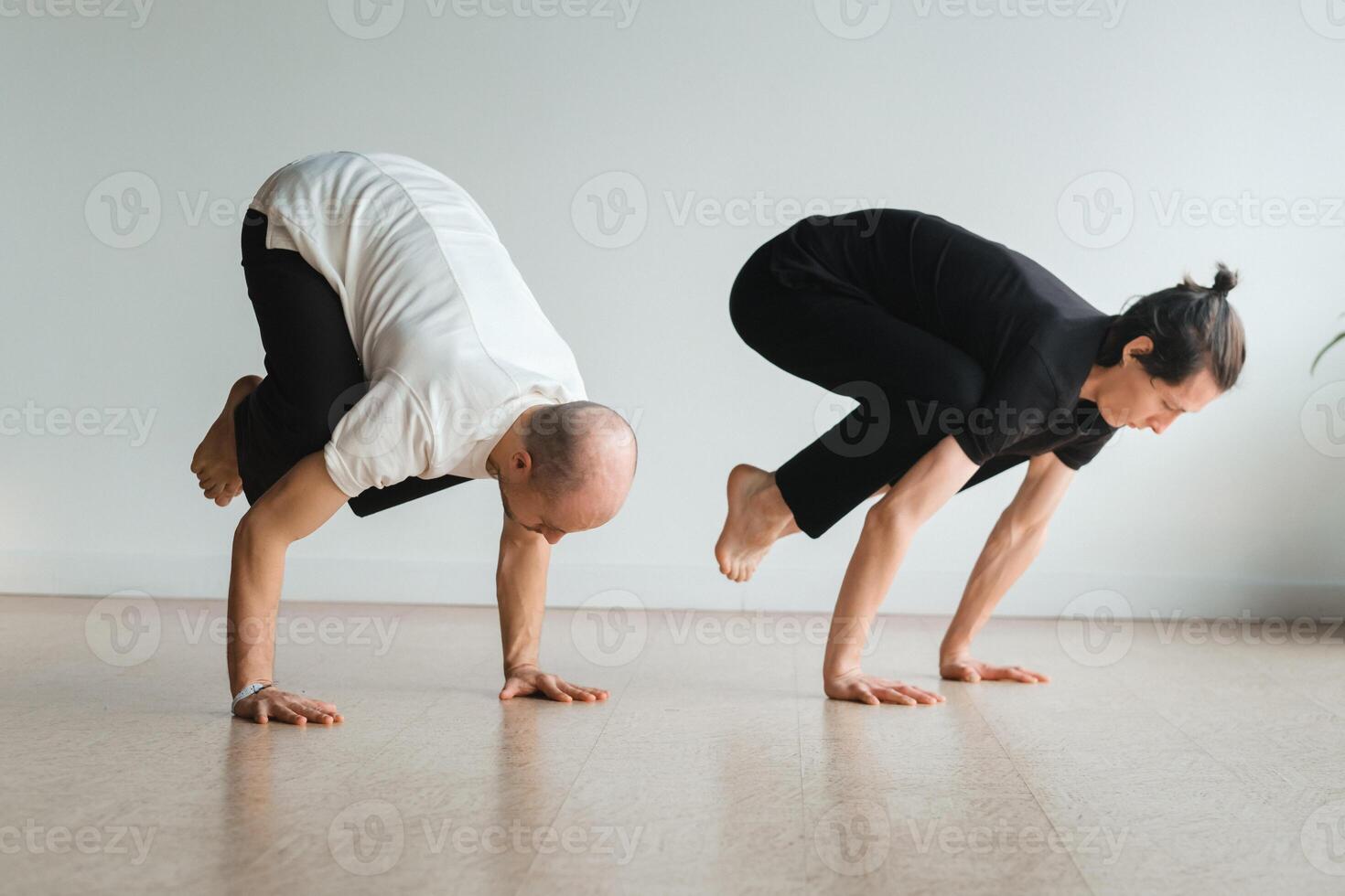 two young athletes practice yoga in the gym. Joint training, indoors, studio. The concept of a healthy lifestyle photo