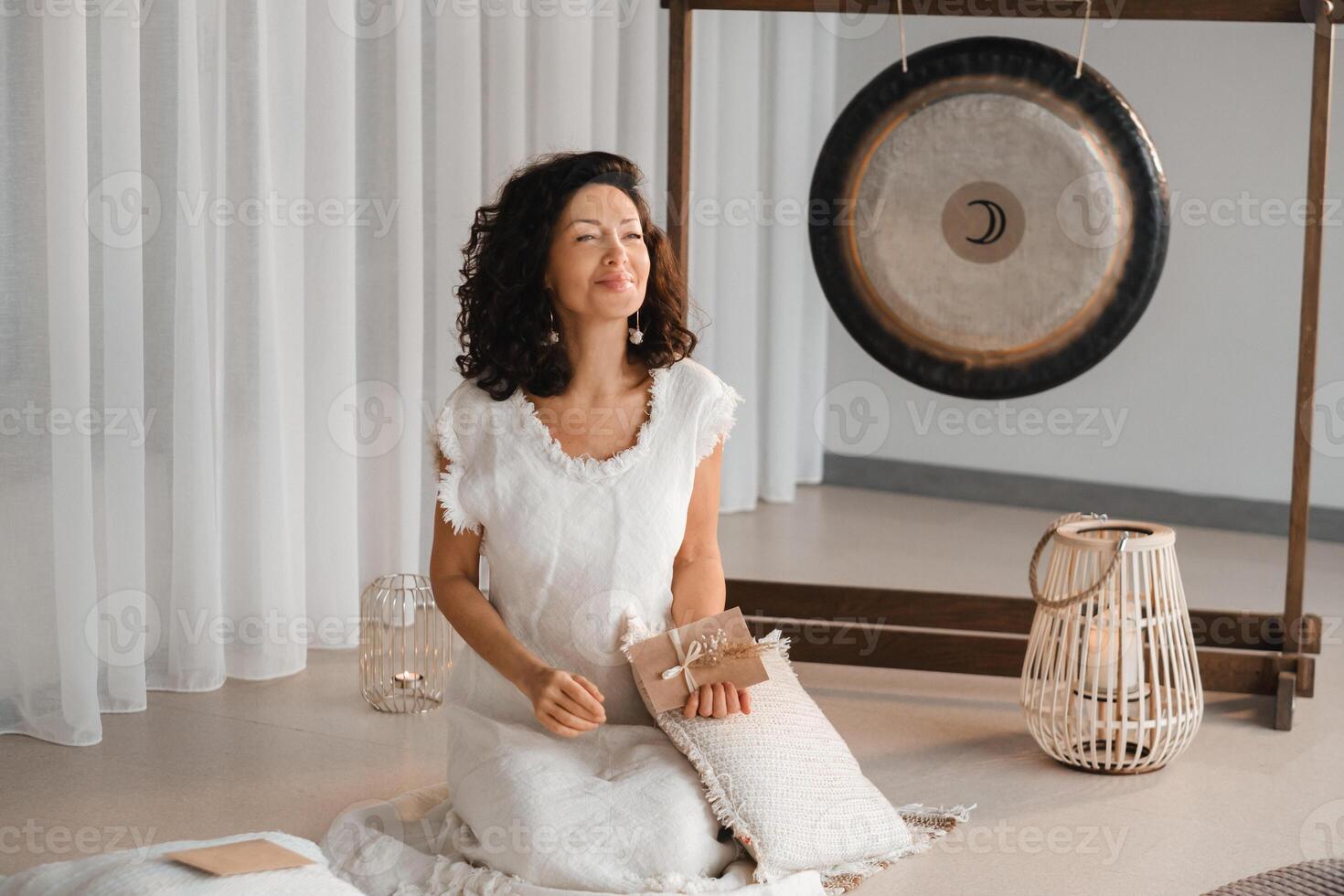 A woman in white clothes holds an envelope with a wish in her hands. The concept of a women's circle photo