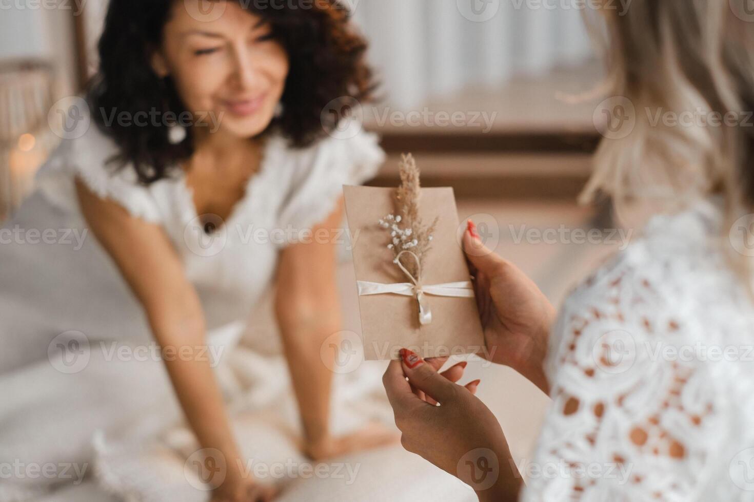 A woman in white clothes holds an envelope with a wish in her hands. The concept of a women's circle photo