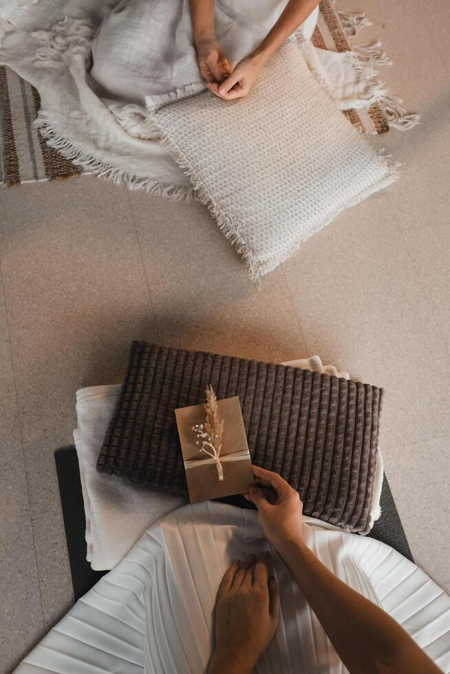 A woman in white clothes is sitting in front of an envelope with a wish for another woman. The concept of the women's circle photo