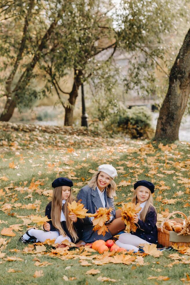 A big family on a picnic in the fall in a nature park. Happy people in the autumn park photo