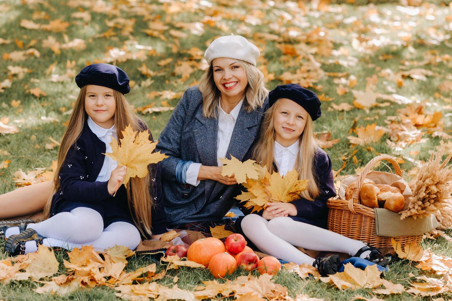 A big family on a picnic in the fall in a nature park. Happy people in the autumn park photo