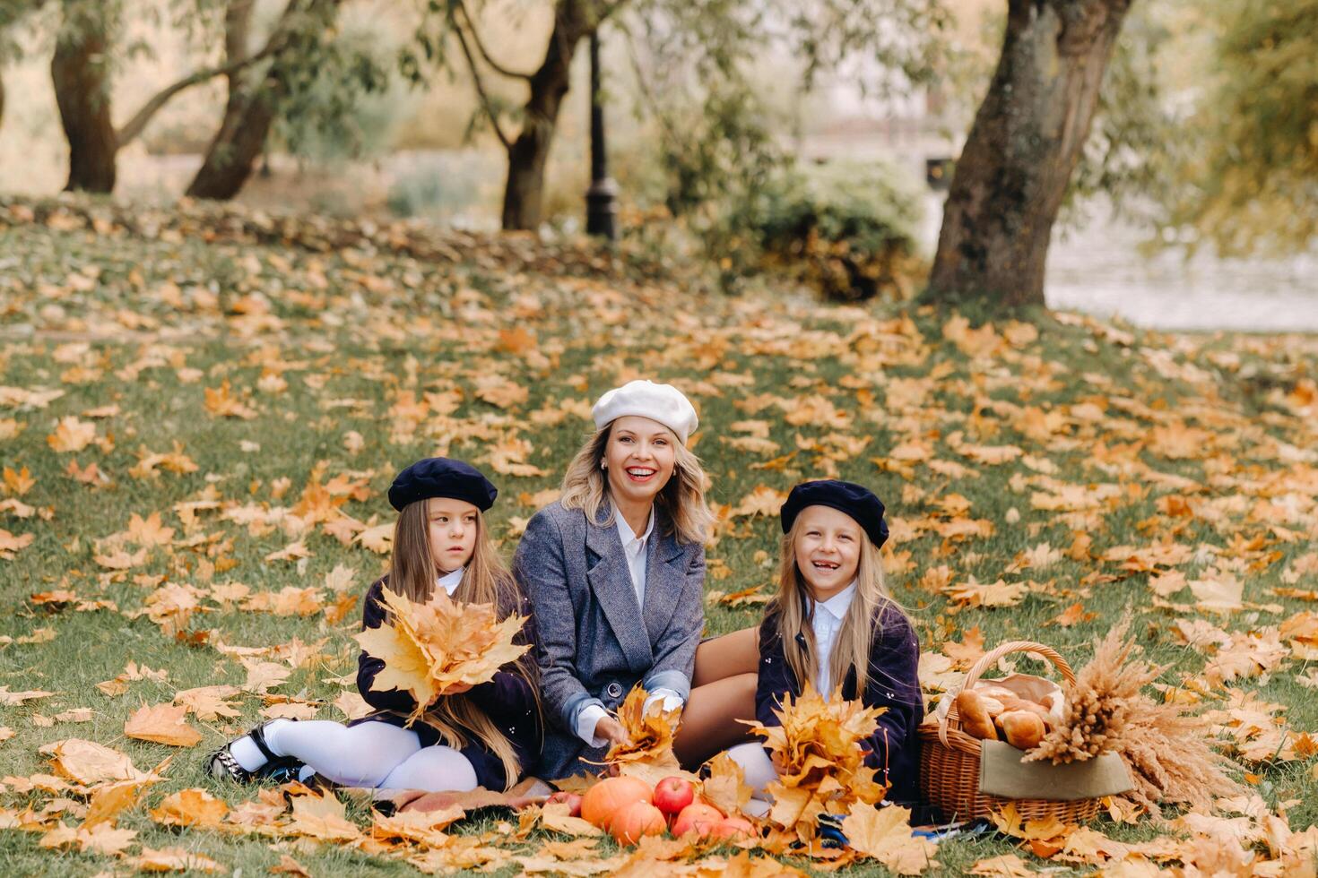 A big family on a picnic in the fall in a nature park. Happy people in the autumn park photo