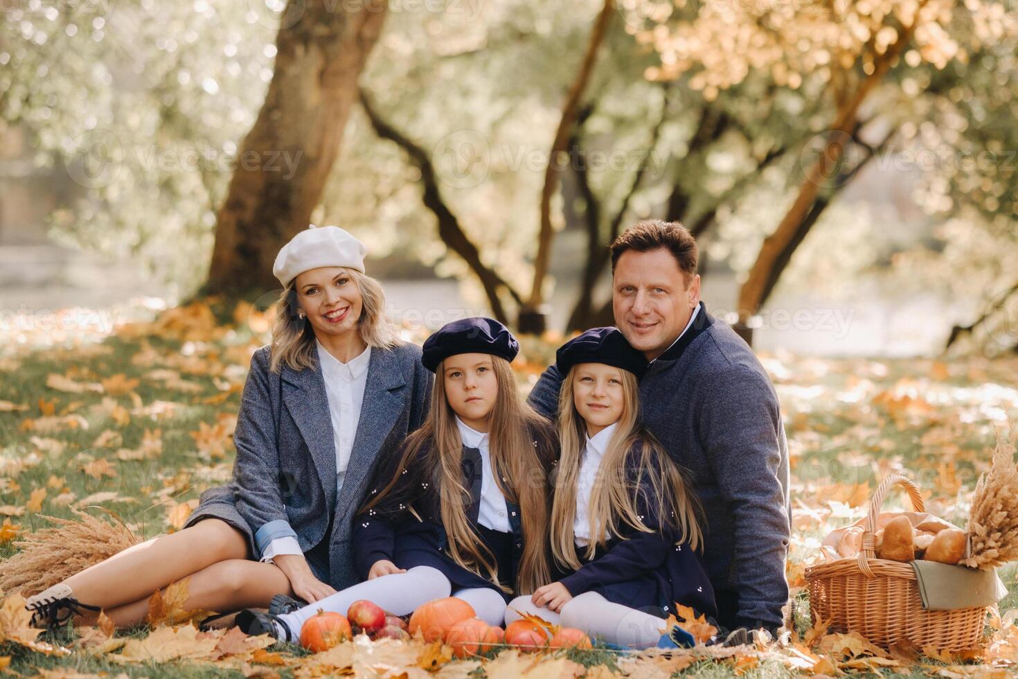 A big family on a picnic in the fall in a nature park. Happy people in the autumn park photo