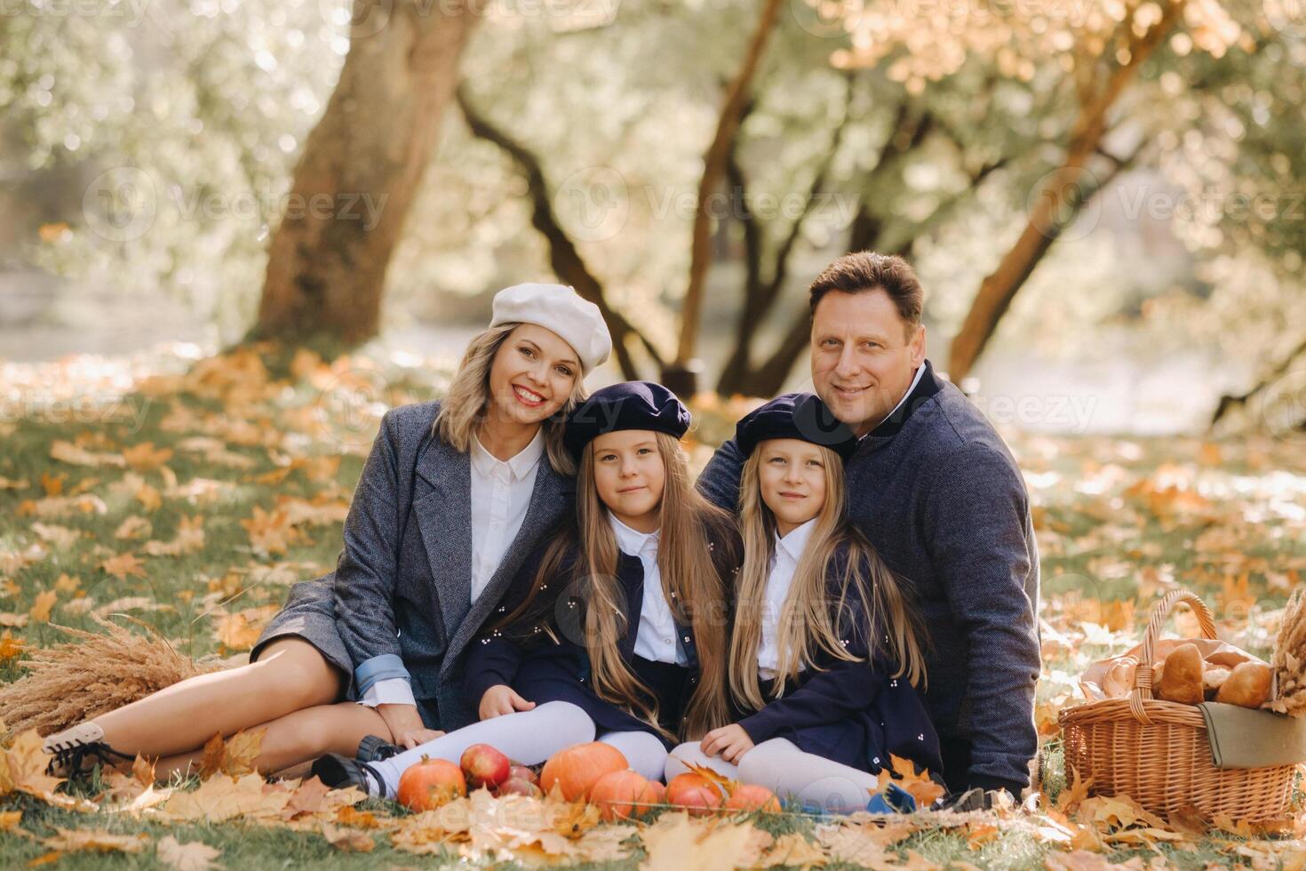 A big family on a picnic in the fall in a nature park. Happy people in the autumn park photo