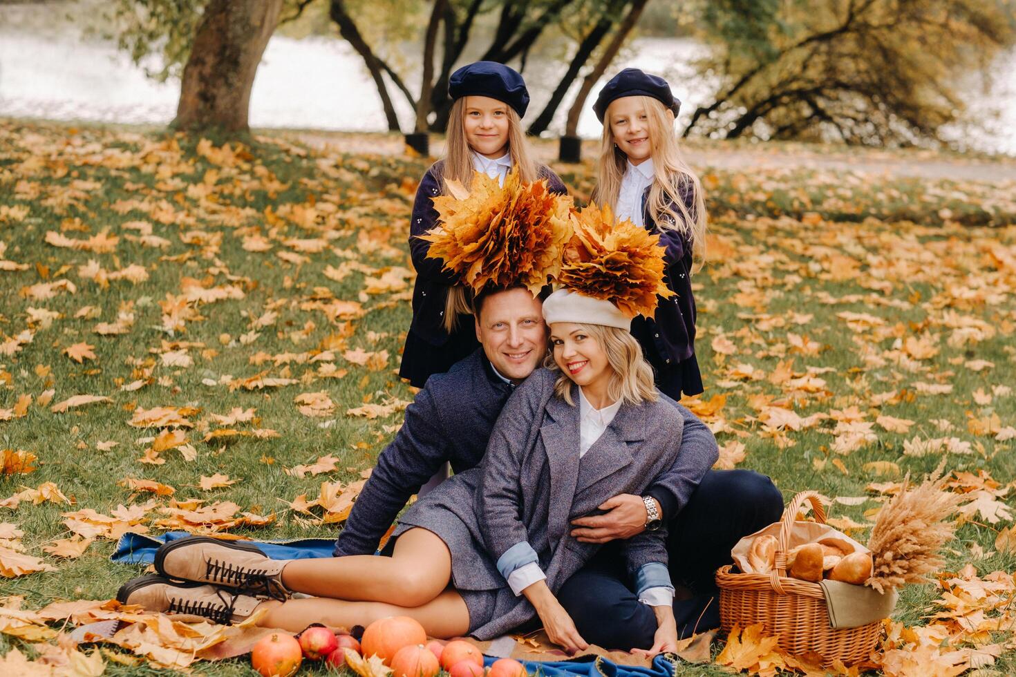 A big family on a picnic in the fall in a nature park. Happy people in the autumn park photo