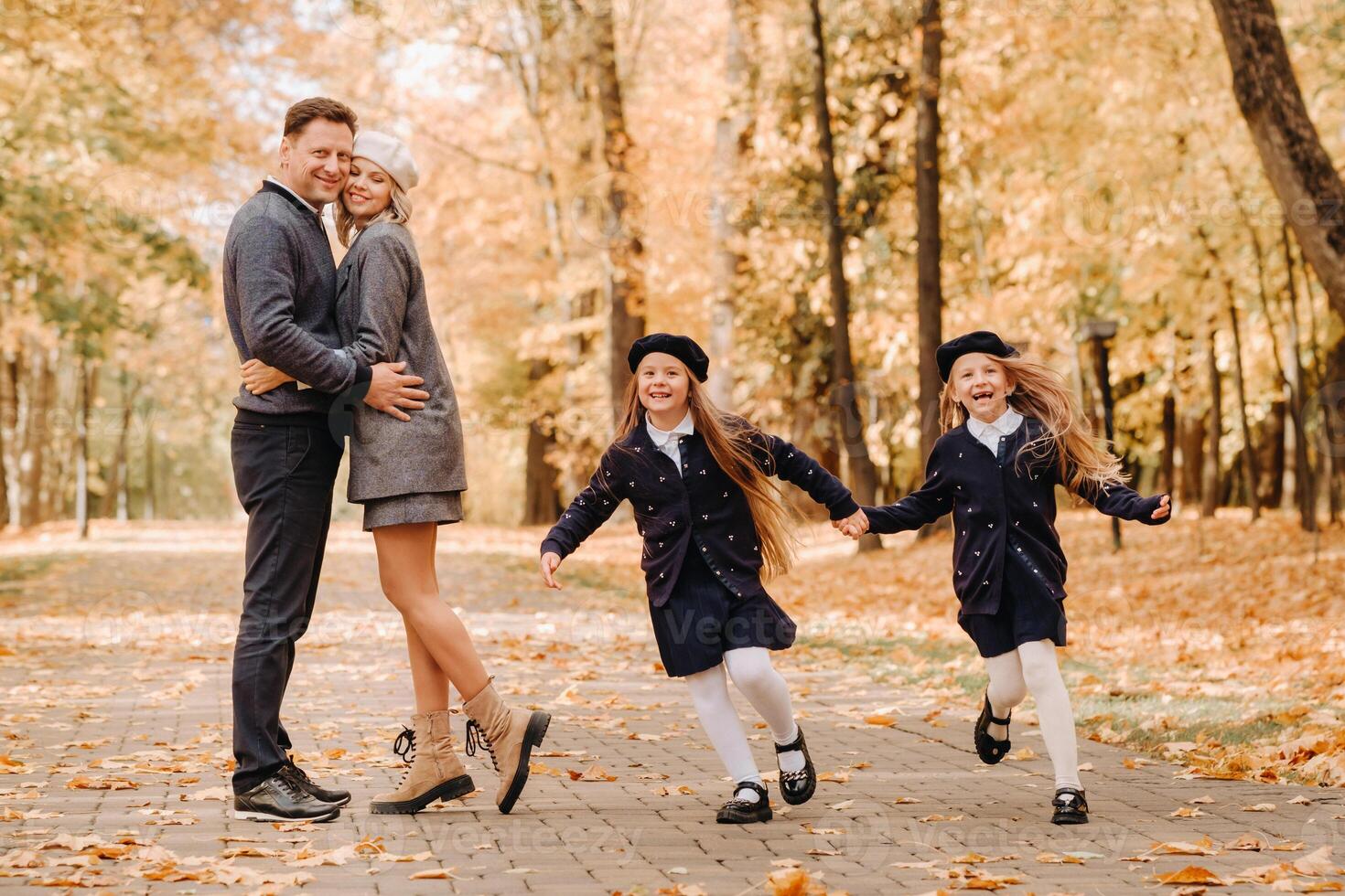 A large family walks in the park in the fall. Happy people in the autumn park photo