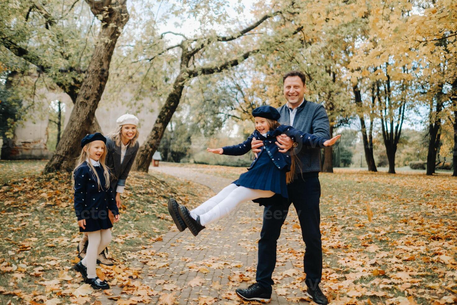 A large family walks in the park in the fall. Happy people in the autumn park photo