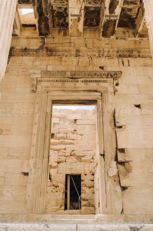 Ancient Greek ruins of Propylaea on a top of Acropolis hill in Athens. Acropolis - main tourist attraction of Athens. Greece. photo