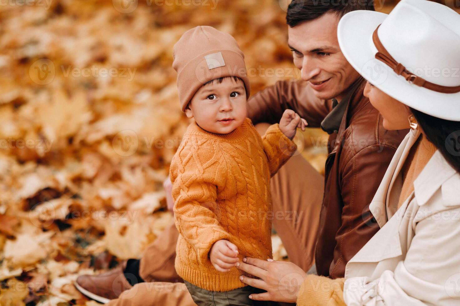Father and mother with son walking in the autumn Park. A family walks in the Golden autumn in a nature Park. photo