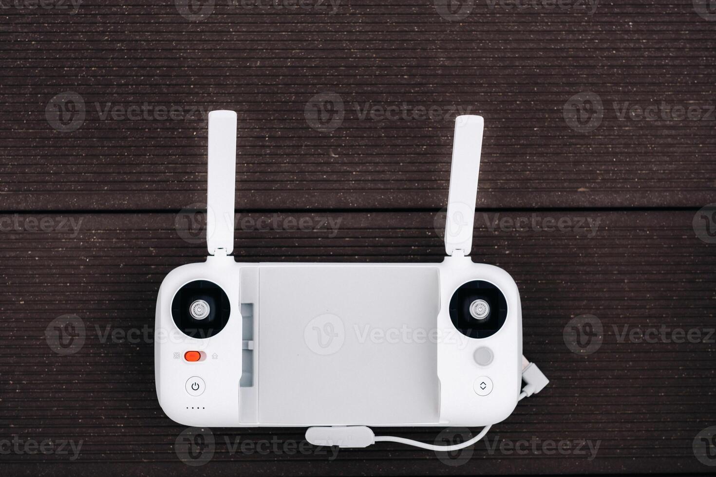 The remote control quadcopter white color.flight controller on an old wooden background. The view from the top, photo