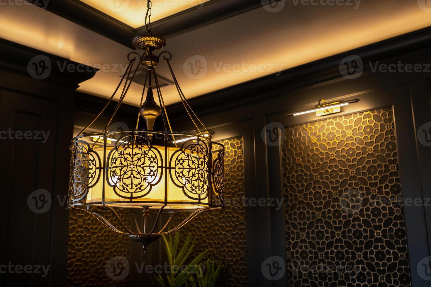 metal lamp in oriental style on the ceiling of the interior photo