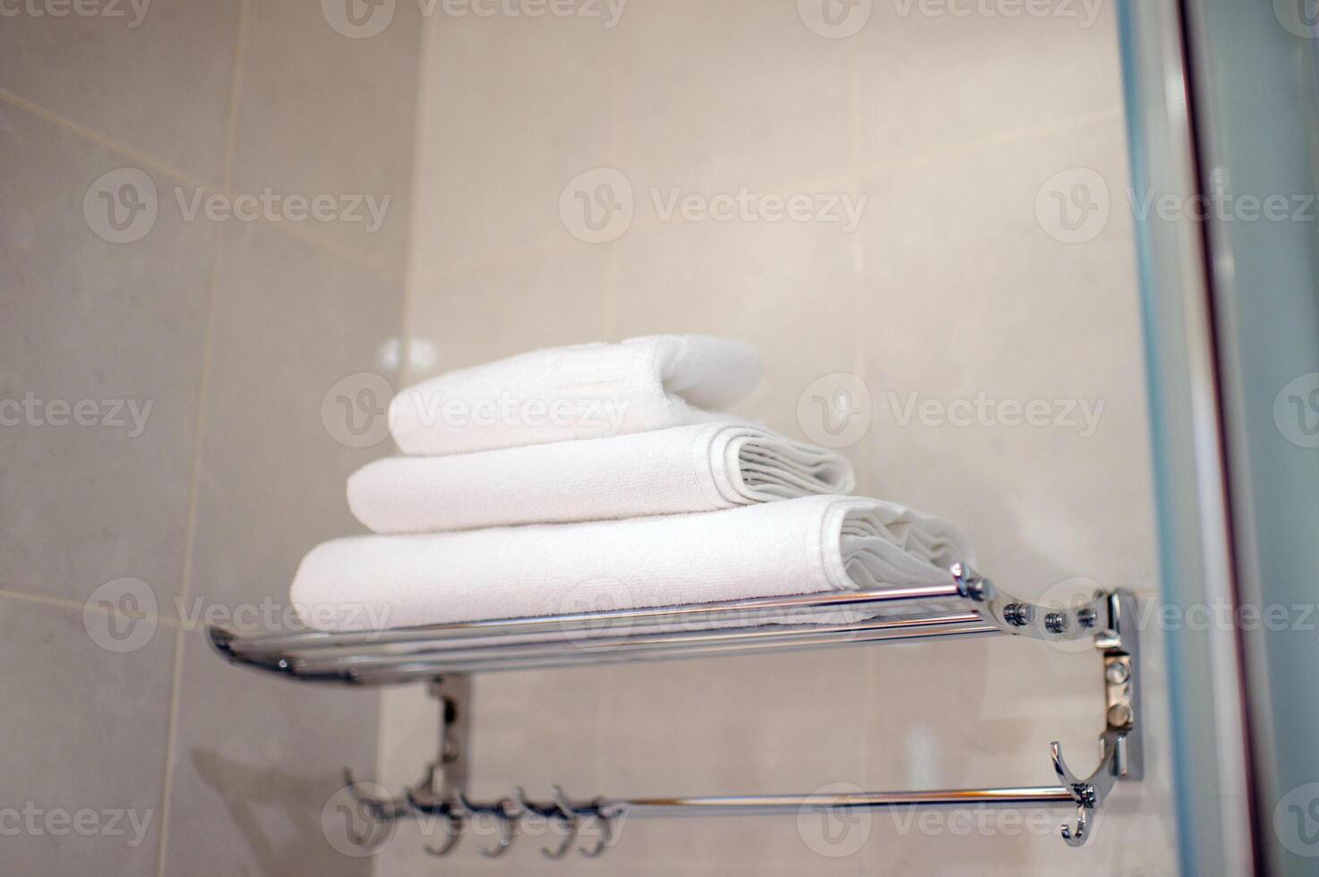 A stack of white towels in the hotel bathroom.set of towels for washing photo