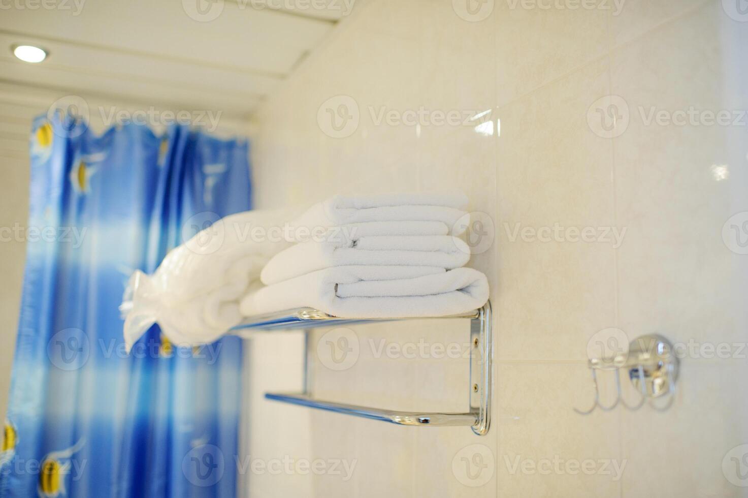A stack of white towels in the hotel bathroom.set of towels for washing photo