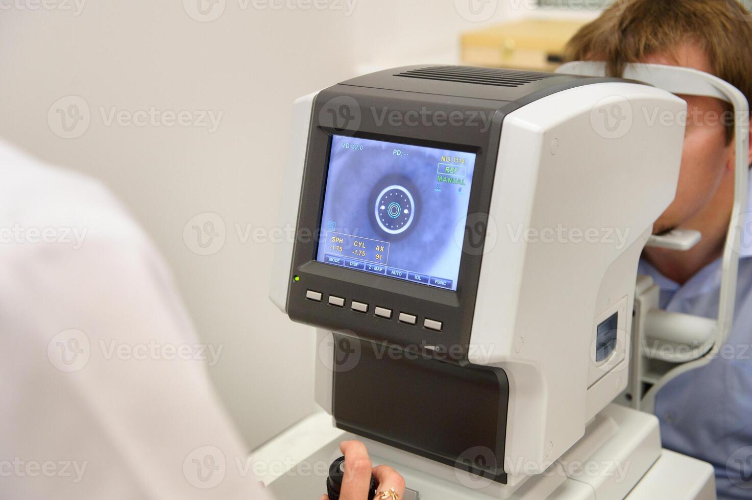 the optometrist controls the oculist display with the scanned eyes of the man, diagnostic ophthalmological equipment photo