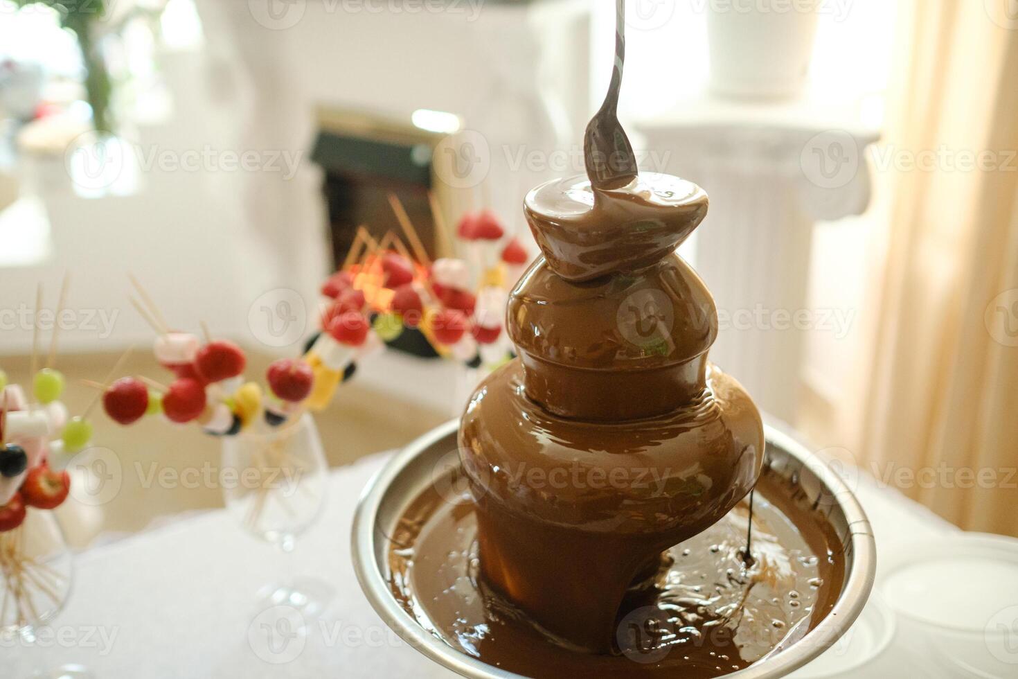 Fondue with a chocolate fountain and sweets for it.Sweet theme photo
