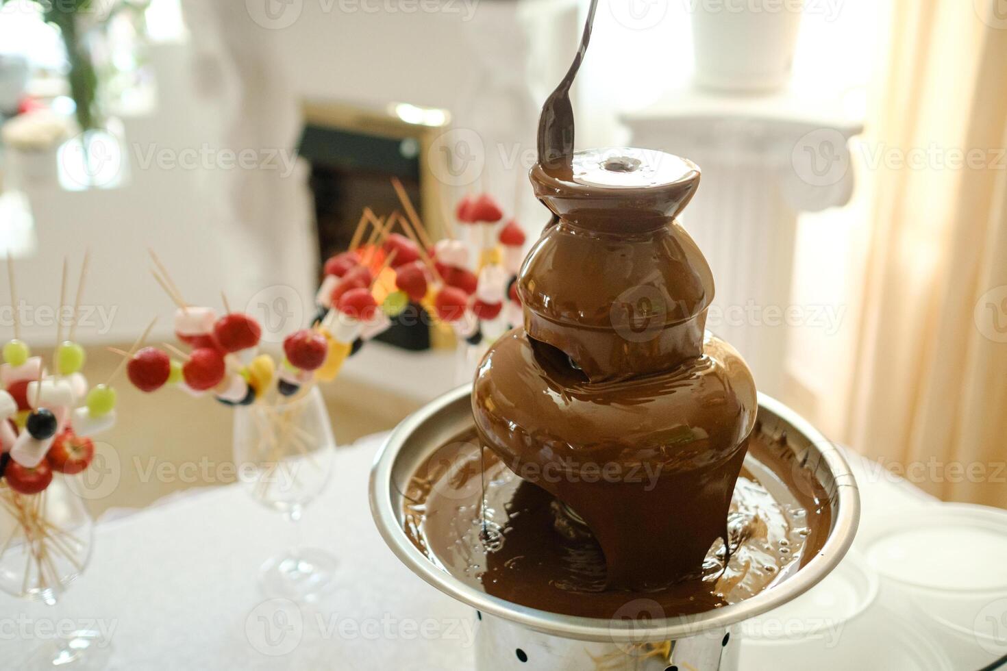 Fondue with a chocolate fountain and sweets for it.Sweet theme photo