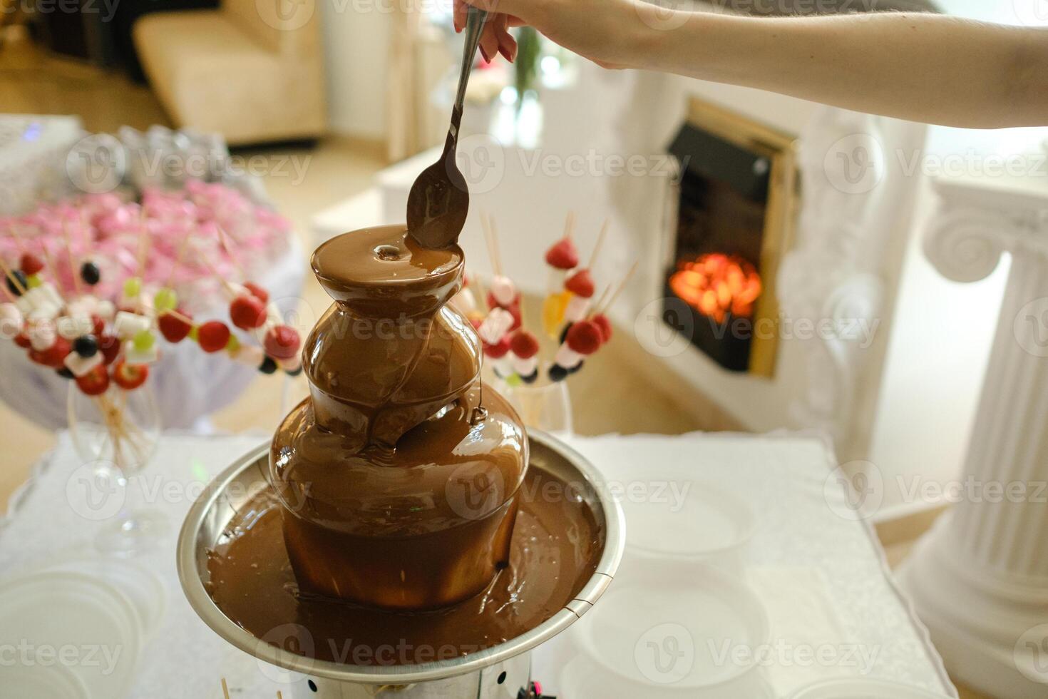 Fondue with a chocolate fountain and sweets for it.Sweet theme photo