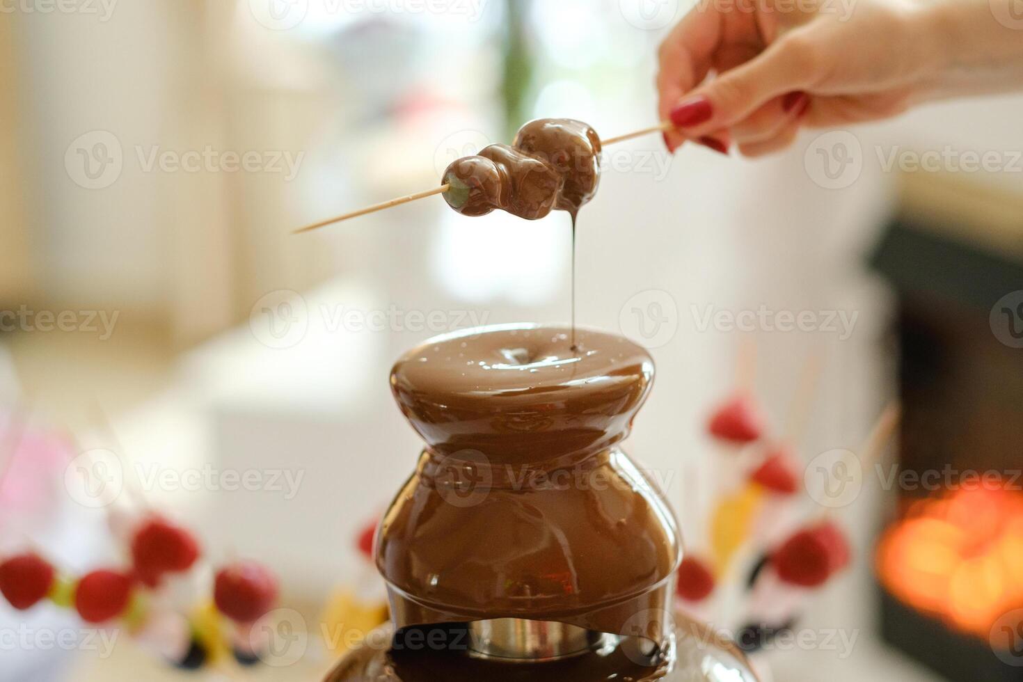 Fondue with a chocolate fountain and sweets for it.Sweet theme photo