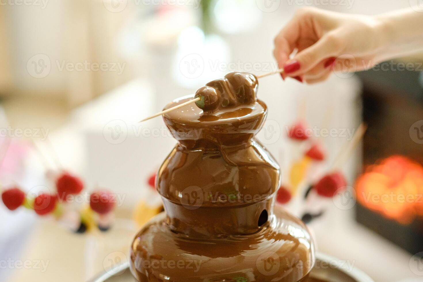 Fondue with a chocolate fountain and sweets for it.Sweet theme photo