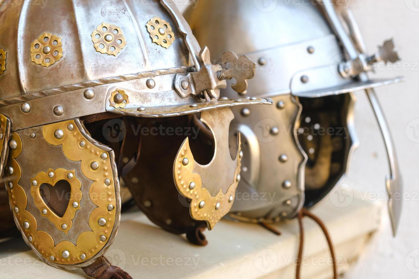 Two knight's helmets are lying on the surface.Medieval concept photo