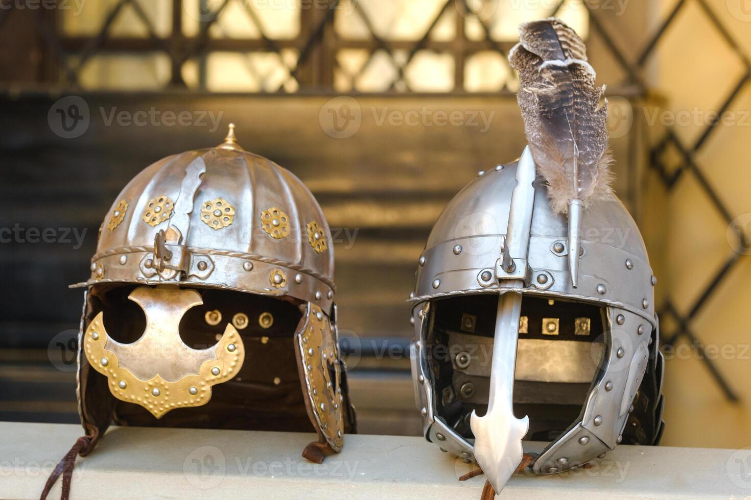 Two knight's helmets are lying on the surface.Medieval concept photo