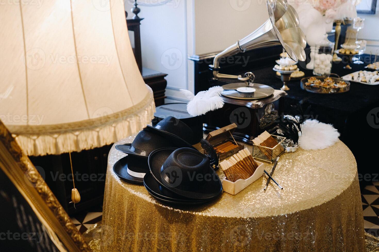 An old retro gramophone, hats and cigars are on the table photo