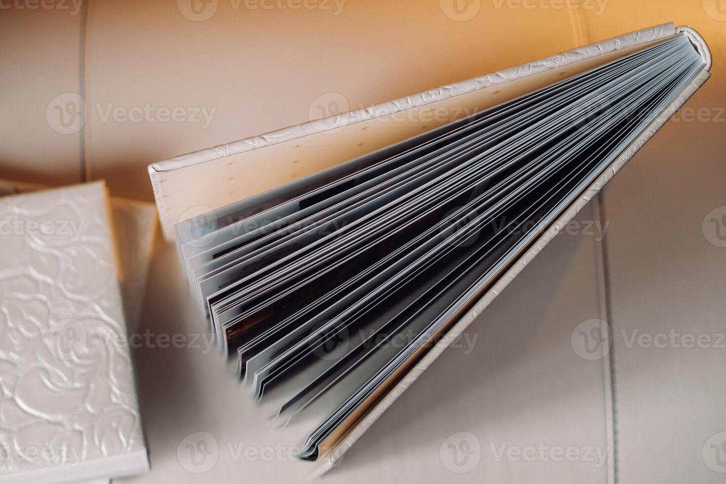 Composition of photo books in genuine white leather . Fragment of a photobook binding